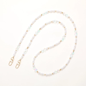 Close-up of pearl phone strap with golden beads and iridescent butterfly charms