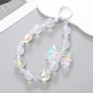 Iridescent bow and heart bead phone charm with a white spring ring clasp on a purple base