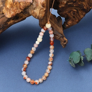 Handmade Bodhi agate bead phone charm with natural multicolored stones on blue background