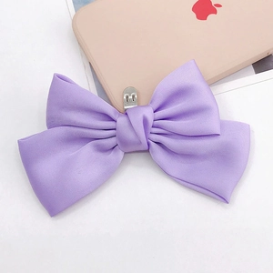 Macro view of light purple satin bow with soft luster and delicate fabric texture