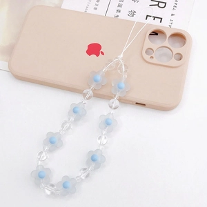 Close-up of frosted flower beads and light blue pearls on a beaded phone wrist strap