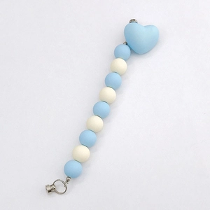 Detail of light blue and cream silicone bead pacifier clip with heart buckle and metal ring