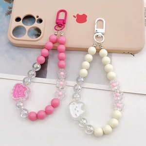 Pink and cream acrylic beaded rabbit phone charms with floral decor and metal hooks