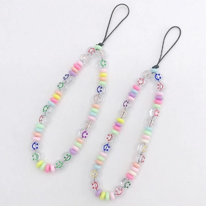Close-up of macaron colored beaded phone straps with colorful smiley face charms