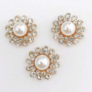 Macro view of zinc alloy sunflower charms with white pearls and clear rhinestones