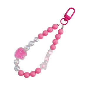 Pink beaded phone charm with acrylic bear pendant and lobster clasp on white background