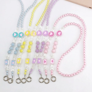 Detail of colorful acrylic beaded phone straps with butterfly and flower charms