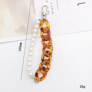 Detail of 165mm heart pendant chain with amber acrylic links and white pearls