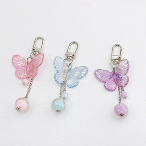 Portachiavi a farfalla in resina rosa, blu e viola con dettagli scintillanti di glitter fini