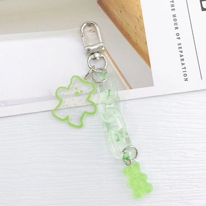 Detail of green acrylic bear keychain featuring glitter resin charm and sturdy link chain