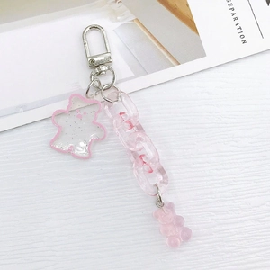 Detailed view of pink acrylic bear keychain with chunky chain and glittery resin charms