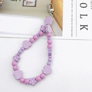 Detail of purple handmade beaded keychain with heart and flower beads and lobster clasp
