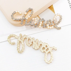 Detailed view of luxury zinc alloy letter charms with inlaid pearls and sparkling crystals