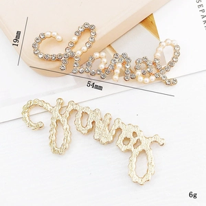 Zinc alloy Chanel-style brooch set with sparkling rhinestones and white pearls