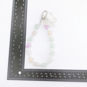 Beaded heart phone charm with a translucent butterfly pendant and lobster clasp