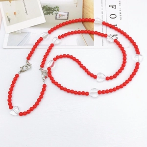 Macro shot of red acrylic heart beads on a detachable crossbody chain with metal lobster clasps