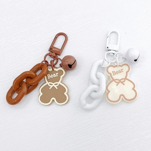 Detail of cute acrylic bear keychains with matching chains and bells for bags