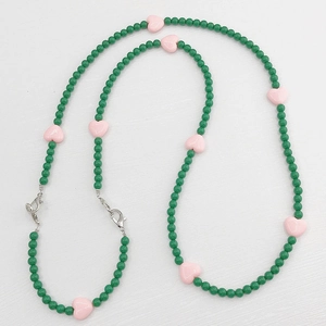 Detail of beaded acrylic chain with dark green beads and pink hearts with lobster clasps