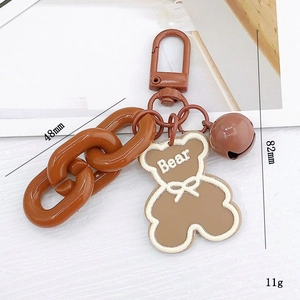 Brown acrylic bear keychain with chunky chain and bell accessory for bags and earphones