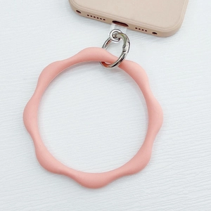 Close-up of pink wave-shaped silicone wrist strap with metal clasp and clear patch