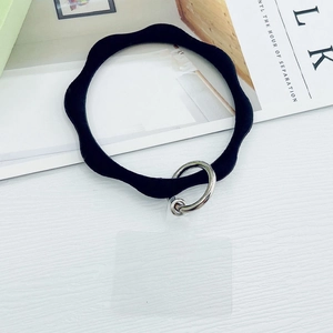 Macro view of black silicone wavy phone wrist strap with silver metal buckle and clear pad