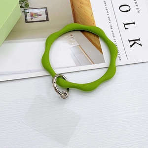 Detail view of a grass green wavy silicone wristband keychain with silver spring ring clasp