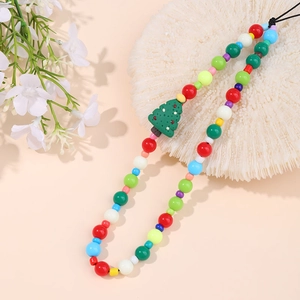 Vue macro d'une dragonne de téléphone en perles colorées avec breloque sapin de Noël vert