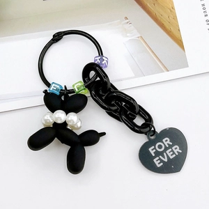Detail of black matte balloon dog keychain with pearl necklace and heart charm