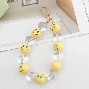 Detail showing yellow smiley face beads and transparent round beads with gold clasp