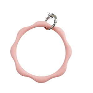Pink silicone wavy wristlet keychain with silver metal spring ring on white background