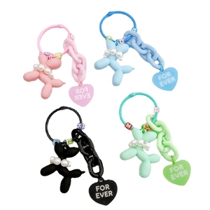 Colorful balloon dog keychains with pearls and heart tags in pink, blue, black, and green