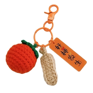 Handmade crochet persimmon and peanut keychain with orange clasp for bag charm