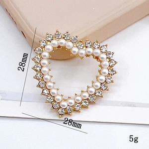 Macro view of heart-shaped charm with pearls and rhinestones for shoe decoration