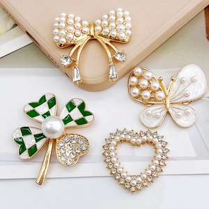 Set of four elegant pearl and rhinestone shoe charms with butterfly and heart shapes