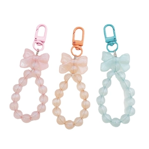 Three-pack beaded bow keychains in pink, orange, and blue for phone case decoration