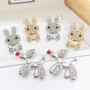 Detailed close-up of sparkling rhinestone bunny and balloon dog DIY jewelry accessories
