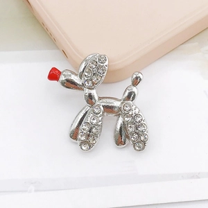 Macro shot of a silver balloon dog charm with sparkling rhinestones and a red nose detail