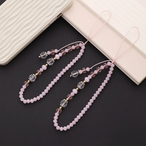 Pink and clear crystal beaded phone charm straps displayed on a sleek black background