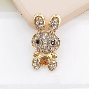Detailed view of a gold-plated rabbit charm featuring white rhinestones and black gem eyes