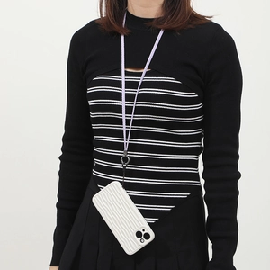 Model wearing a white wave texture phone case with a lavender braided lanyard attachment