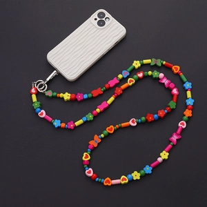 Macro detail of candy-colored acrylic beads and silver lobster clasp on phone strap