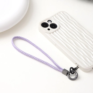 Macro view of purple braided leather phone lanyard and white wavy texture phone case