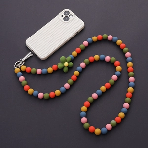 Macro detail of colorful matte candy beads lanyard with green flower on white wave case