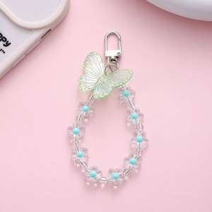 Detail of beaded keychain with a light green resin butterfly and blue flower beads