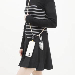 Crossbody phone lanyard with beige woven cord and metallic hardware shown on a model