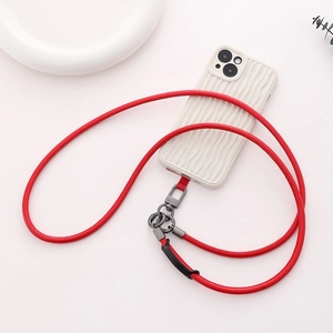 Detail of red leather crossbody phone lanyard with durable grey metal buckle on white case