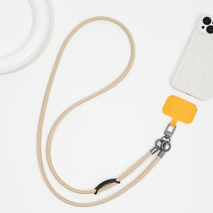 Detail view of durable beige leather crossbody phone lanyard with orange TPU patch