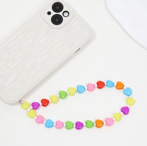 Colorful heart-shaped beaded phone charm strap with bright acrylic beads on a cream case