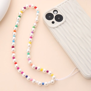 Detail of colorful beaded phone strap with pearls on wavy textured phone case