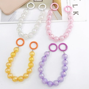 Detail of four colorful beaded phone straps with unique crackle texture and round clips